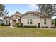 Single-story home with light gray siding, tile roof, and landscaping at 31722 Red Tail Blvd, Sorrento, FL 32776