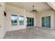 Covered patio with tile floor, ceiling fan, and sliding doors at 31722 Red Tail Blvd, Sorrento, FL 32776