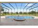 Inviting pool and spa with a screened enclosure at 31722 Red Tail Blvd, Sorrento, FL 32776