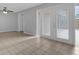 Bright living room featuring tiled floors and glass doors that let in natural light at 881 Town Cir # 129, Maitland, FL 32751