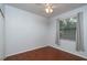 Bright bedroom featuring wood floors and a window with blinds at 898 Arbormoor Pl, Lake Mary, FL 32746