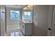 Modern bathroom with double vanity, marble floors, and large window at 1189 Basalt Ln, Sanford, FL 32771