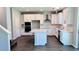 Modern kitchen features white cabinets, a kitchen island, stainless steel appliances, and hardwood floors at 1189 Basalt Ln, Sanford, FL 32771