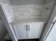 White shaker kitchen cabinets with quartz countertops and modern hardware at 1189 Basalt Ln, Sanford, FL 32771