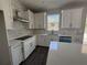 Bright kitchen with white cabinets, quartz countertops, and a stainless steel range hood at 1189 Basalt Ln, Sanford, FL 32771