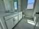 Bright bathroom featuring double sinks, quartz countertop, and tiled floors at 1193 Basalt Ln, Sanford, FL 32771