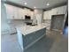 Bright kitchen featuring white cabinets, a center island, and modern stainless steel appliances at 1193 Basalt Ln, Sanford, FL 32771