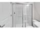 Bathroom featuring tiled shower with glass doors and neutral color palette at 1211 Teal Creek Dr, St Cloud, FL 34771
