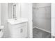 Bathroom and closet space with white cabinets, sleek fixtures and carpeted floors at 1211 Teal Creek Dr, St Cloud, FL 34771