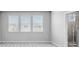 Empty bedroom featuring carpeted floor, 3 windows, and ensuite bathroom at 1211 Teal Creek Dr, St Cloud, FL 34771