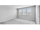 Bright bedroom with neutral walls, plush carpet, and large windows offering natural light at 1211 Teal Creek Dr, St Cloud, FL 34771