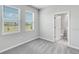 Comfortable bedroom featuring plush carpet, sun-filled windows, and an attached bathroom at 1211 Teal Creek Dr, St Cloud, FL 34771