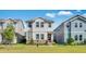 Charming two-story home featuring stone accents, landscaping, and a well-maintained green lawn at 1211 Teal Creek Dr, St Cloud, FL 34771