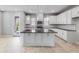 Beautiful kitchen with white cabinets, stainless steel appliances, and island with dark countertops at 1211 Teal Creek Dr, St Cloud, FL 34771
