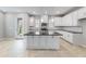 Bright, modern kitchen with white cabinets, stainless steel appliances, and a dark countertops at 1211 Teal Creek Dr, St Cloud, FL 34771