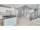 Bright, open-concept living area with stylish tile flooring, stairs, and access to the modern kitchen at 1211 Teal Creek Dr, St Cloud, FL 34771