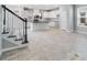 View of the open-concept living space with kitchen, stairs, and stylish tile flooring at 1211 Teal Creek Dr, St Cloud, FL 34771