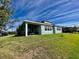 Beautiful backyard featuring a covered patio, lush lawn, and serene outdoor space at 16744 Sanctuary Dr, Winter Garden, FL 34787