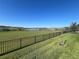 Scenic backyard view with black fence overlooking green space and a serene lake at 16744 Sanctuary Dr, Winter Garden, FL 34787