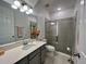 Modern bathroom showcasing a quartz countertop, spacious shower, and contemporary fixtures at 16744 Sanctuary Dr, Winter Garden, FL 34787