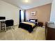 Comfortable bedroom featuring plush carpet, stylish decor, and a well-lit workspace at 16744 Sanctuary Dr, Winter Garden, FL 34787