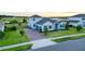 Beautiful two-story home with a manicured lawn and a brick driveway in a suburban neighborhood at 16744 Sanctuary Dr, Winter Garden, FL 34787