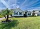 Charming single-story home with well-manicured lawn, lush landscaping, and inviting curb appeal at 16744 Sanctuary Dr, Winter Garden, FL 34787