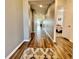 Long hallway with wood flooring and neutral paint leading to various rooms in the house at 16744 Sanctuary Dr, Winter Garden, FL 34787