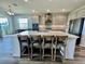 Modern kitchen island with seating, stainless steel appliances, and plenty of cabinet space at 16744 Sanctuary Dr, Winter Garden, FL 34787