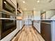 Well-equipped kitchen with stainless steel appliances, modern cabinetry and hardwood floors at 16744 Sanctuary Dr, Winter Garden, FL 34787
