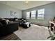 Bright living room with large windows, hardwood floors, and a comfortable sectional sofa at 16744 Sanctuary Dr, Winter Garden, FL 34787