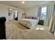 Expansive main bedroom with plush carpet, large windows, and an adjoining sitting area at 16744 Sanctuary Dr, Winter Garden, FL 34787
