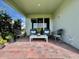Charming covered patio area featuring brick flooring and comfortable seating at 16744 Sanctuary Dr, Winter Garden, FL 34787