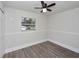 Bright bedroom featuring wood-look floors, ceiling fan, window, and clean, neutral paint at 1913 South Blvd, Maitland, FL 32751