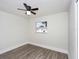 Clean bedroom has wood-look flooring, ceiling fan, and large window at 1913 South Blvd, Maitland, FL 32751
