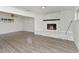 Spacious living room with stone fireplace, ceiling fan, and wood-look floors at 1913 South Blvd, Maitland, FL 32751