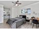 Stylish main bedroom with ceiling fan, connecting bathroom, and a large window at 1913 South Blvd, Maitland, FL 32751