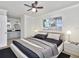 Clean and modern main bedroom with ceiling fan, connecting bathroom, and a large window at 1913 South Blvd, Maitland, FL 32751