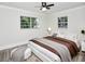 Well-lit bedroom with wood floors, ceiling fan, and modern furniture at 1913 South Blvd, Maitland, FL 32751