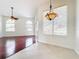 Bright dining area with hardwood floors, large windows, and a chandelier at 1125 English Garden Se Ln, Winter Garden, FL 34787