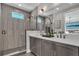 Sleek bathroom features a walk-in shower with stylish tile work, dual sinks, and contemporary fixtures at 2122 Whitney Marsh Aly, Orlando, FL 32804