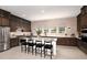 Modern kitchen boasts stainless steel appliances, a large island, and elegant cabinetry for a gourmet cooking experience at 2122 Whitney Marsh Aly, Orlando, FL 32804