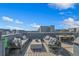 Expansive rooftop deck features comfortable lounge seating and an outdoor dining area, ideal for relaxation at 2122 Whitney Marsh Aly, Orlando, FL 32804
