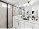 Stylish bathroom with marble tiled shower, double vanity with black fixtures, and modern lighting at 2138 Whitney Marsh Aly, Orlando, FL 32804