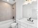 Clean bathroom featuring a modern vanity, and shower-tub combination with neutral tile at 2138 Whitney Marsh Aly, Orlando, FL 32804
