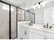 Modern bathroom featuring a double vanity, frameless shower, and matte black hardware at 2138 Whitney Marsh Aly, Orlando, FL 32804