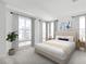 This bedroom offers plenty of natural light with large windows and modern decor, and a neutral color palette at 2138 Whitney Marsh Aly, Orlando, FL 32804