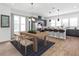 Open concept kitchen with stainless appliances and an eat-in dining area with modern light fixtures at 2138 Whitney Marsh Aly, Orlando, FL 32804