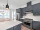 Modern kitchen with island, stainless steel appliances, range hood, and adjacent living room at 2138 Whitney Marsh Aly, Orlando, FL 32804