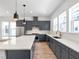 Modern kitchen with gray cabinets, stainless steel appliances, island, and backsplash at 2138 Whitney Marsh Aly, Orlando, FL 32804